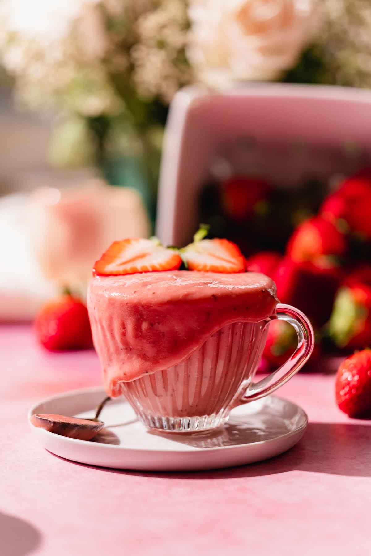 strawberry curd in cup surrounded with fresh strawberries